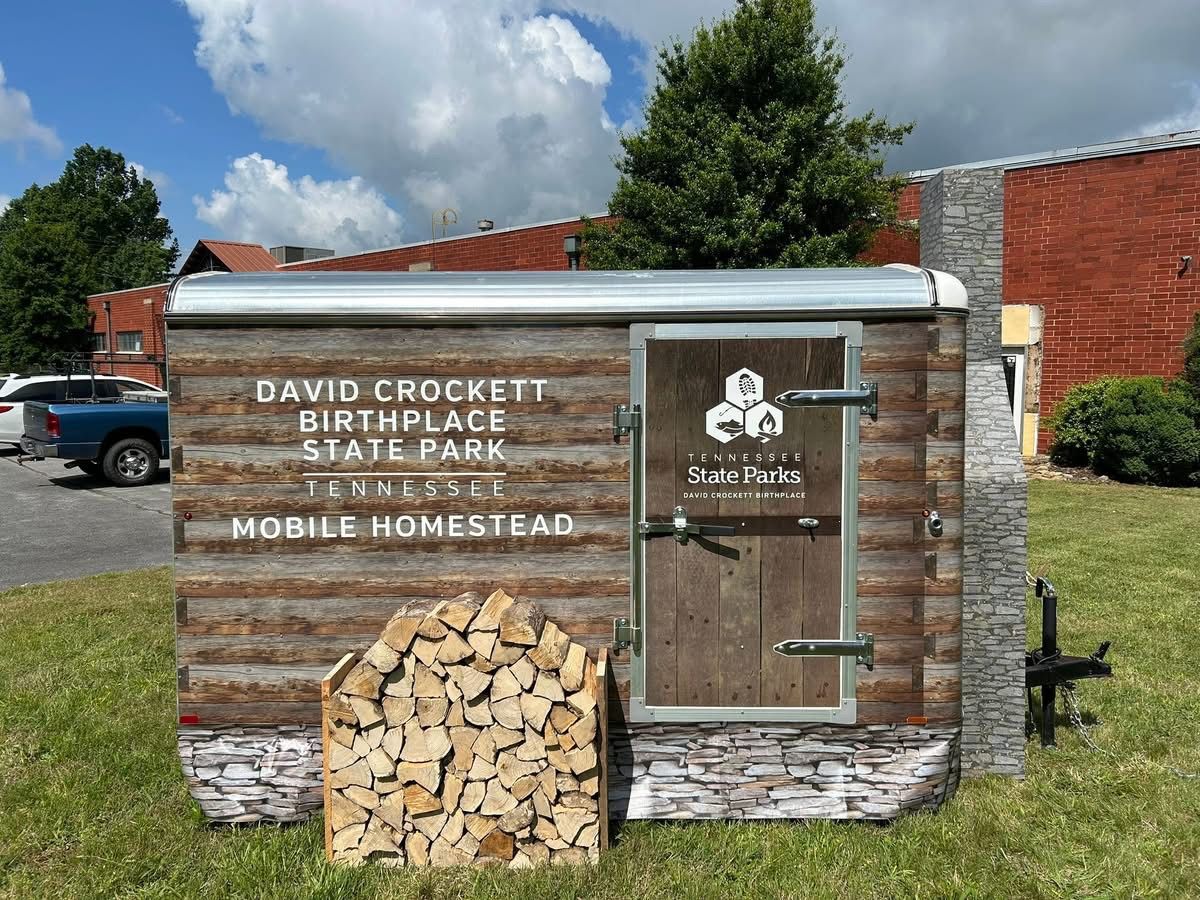 A wooden mobile homestead parked at David Crocket Birthplace State Park