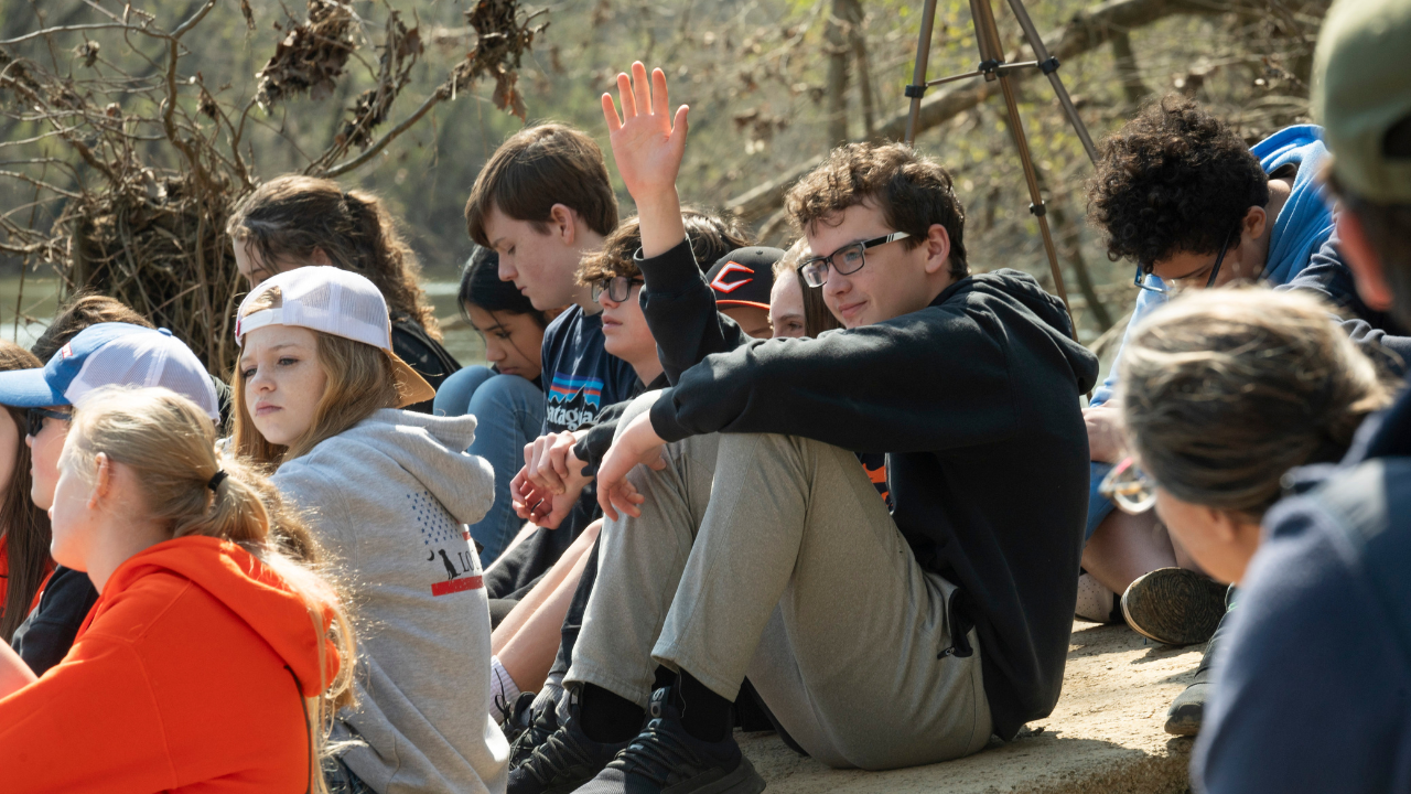 Group of students in a Tennessee State Park engaging with Park staff by answering questions.
