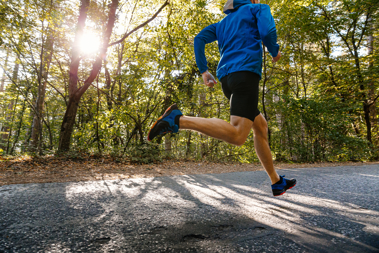 Runner on tree-lined path supporting Run for the Trees virtual 5K Tennessee